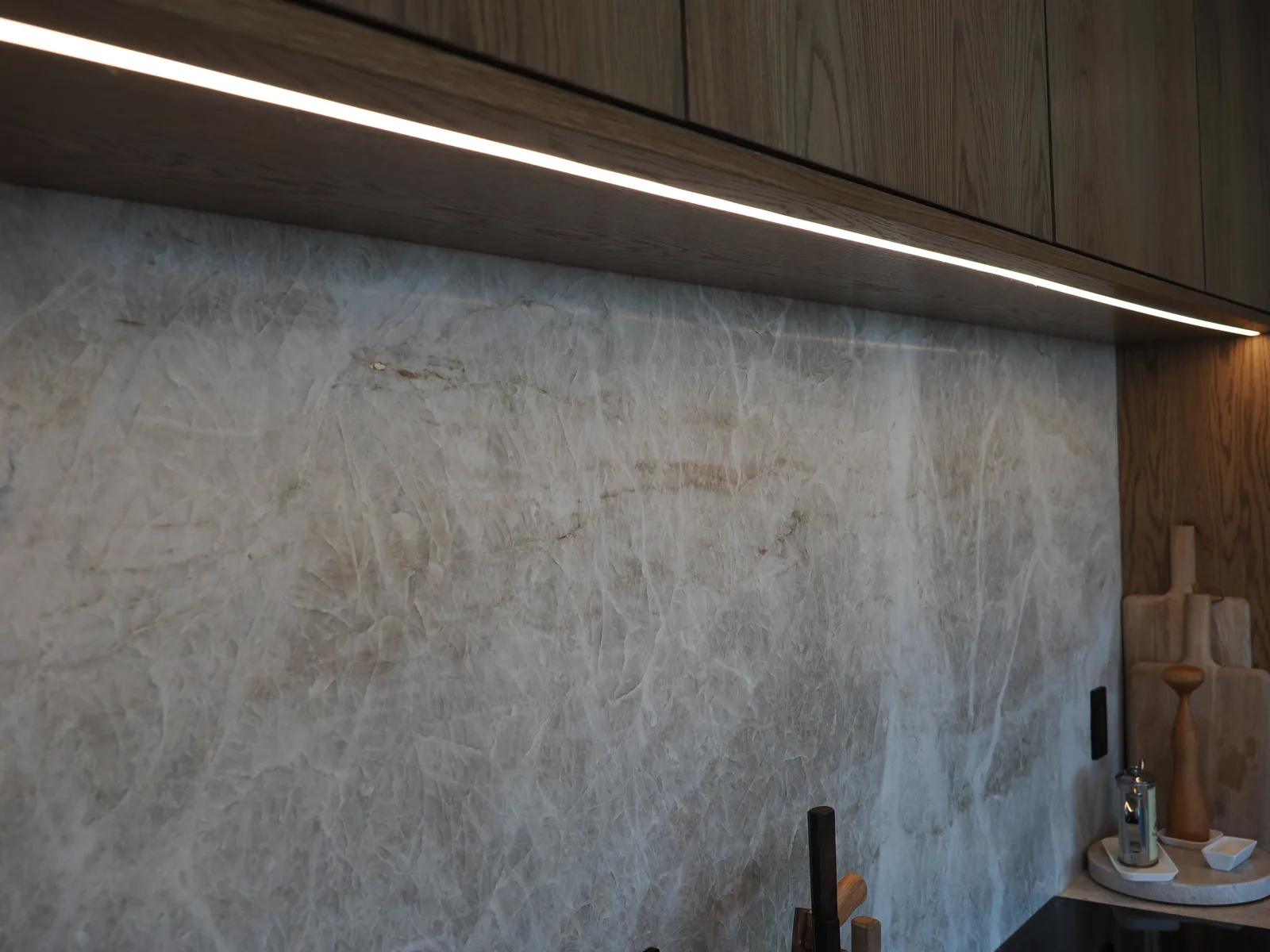 Continuous task light beneath wood-front cabinetry