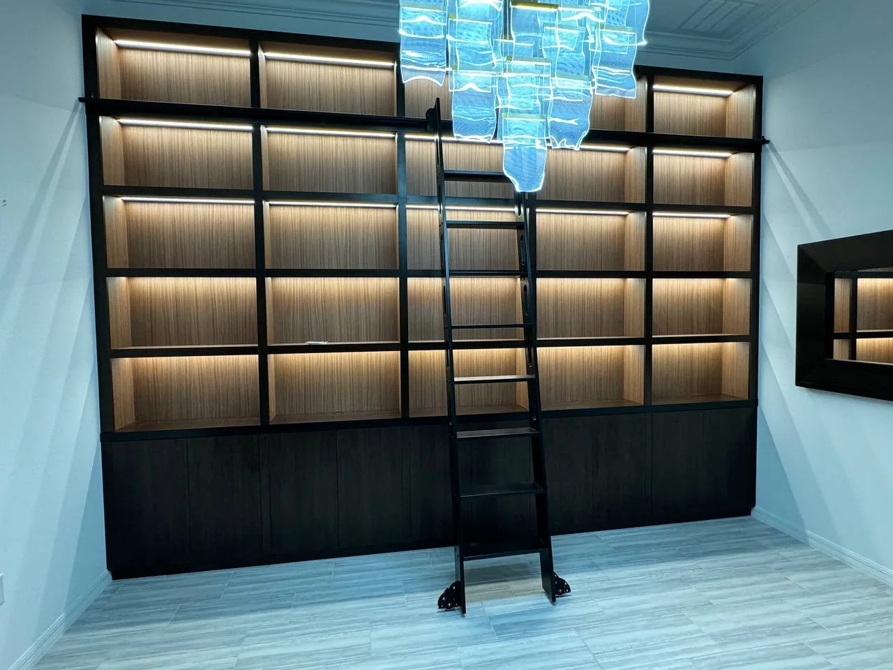 The full display wall with a ladder positioned at the upper shelves