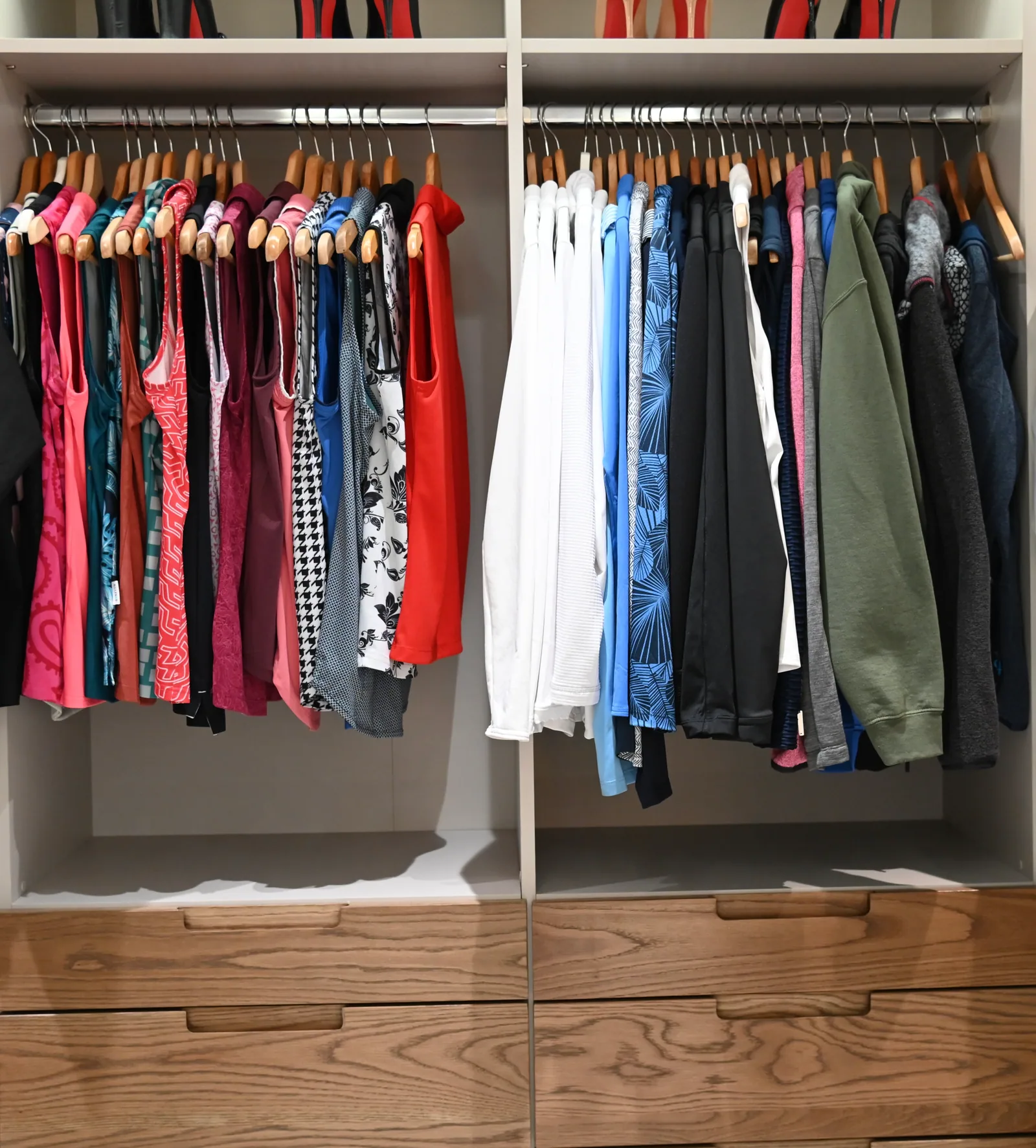 Walk-in closet with open hanging bays and wood-front drawers