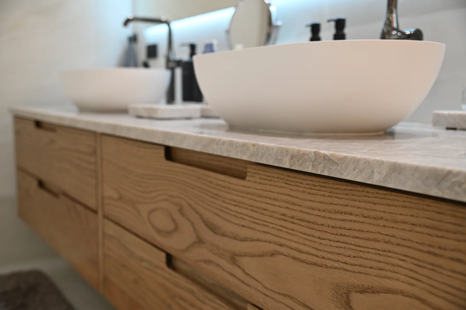 Wood grain across the drawer fronts of a completed LeVika vanity
