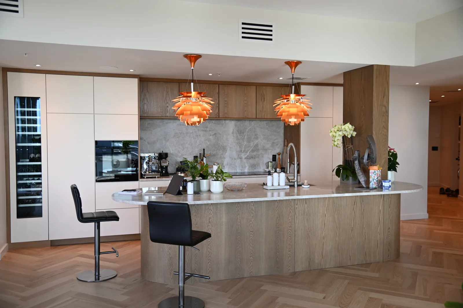Completed wood and white LeVika kitchen with curved island