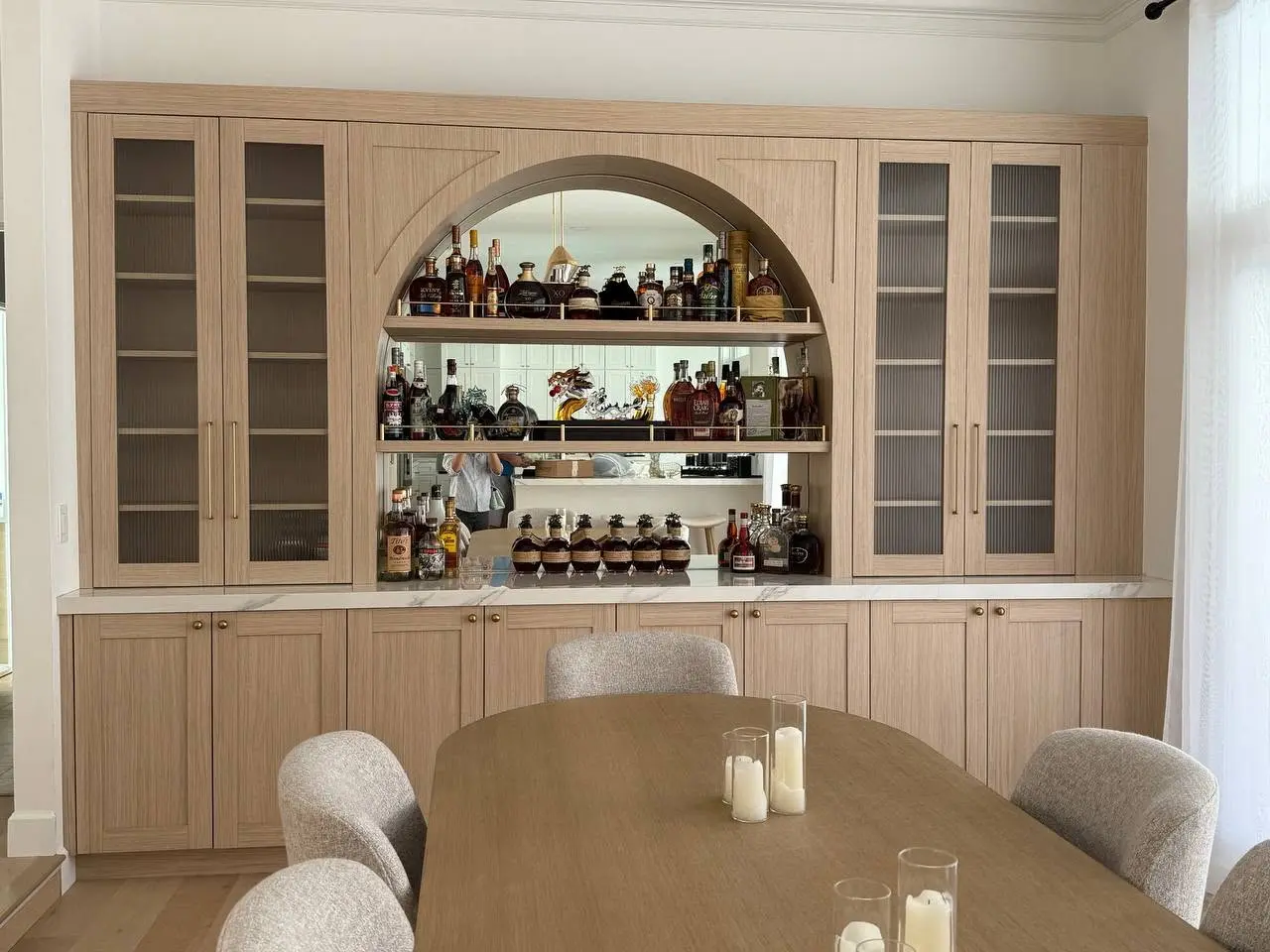 Completed arched home bar demonstrating coordinated whole-home cabinetry by LeVika Furniture
