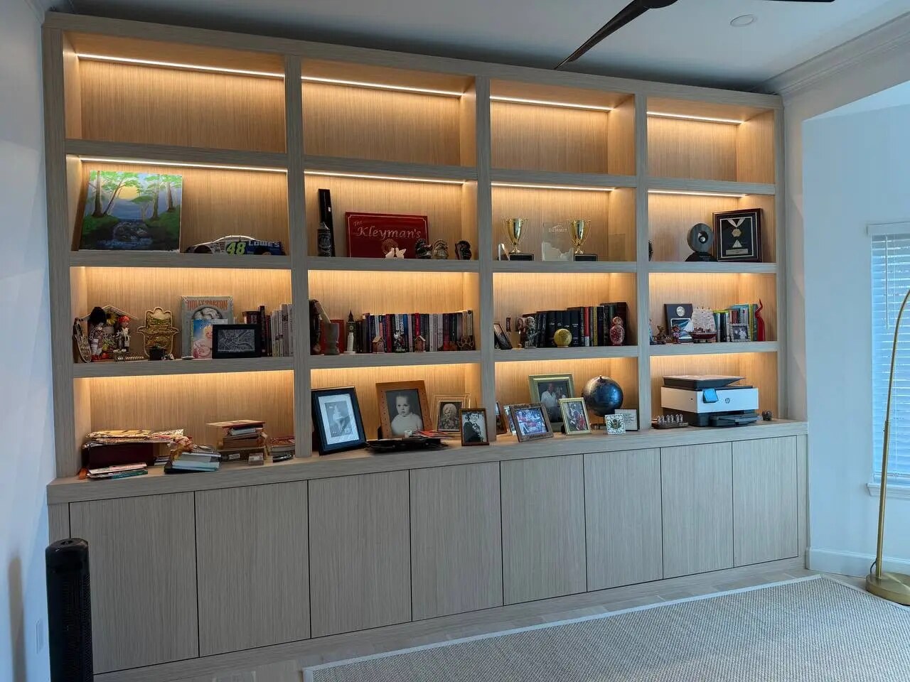 Completed light oak home office library with integrated lighting by LeVika Furniture