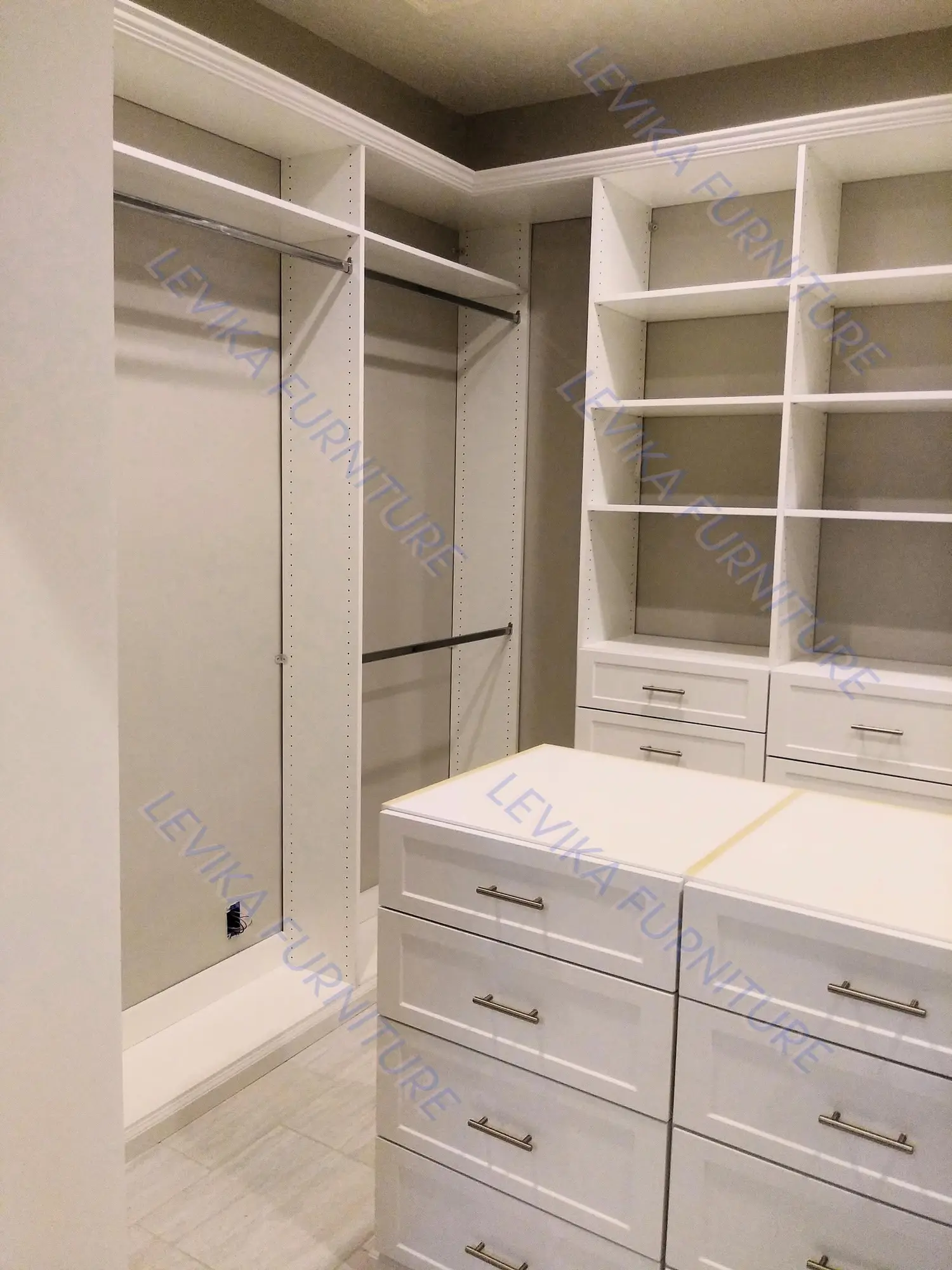 Completed light walk-in closet with central island by LeVika Furniture